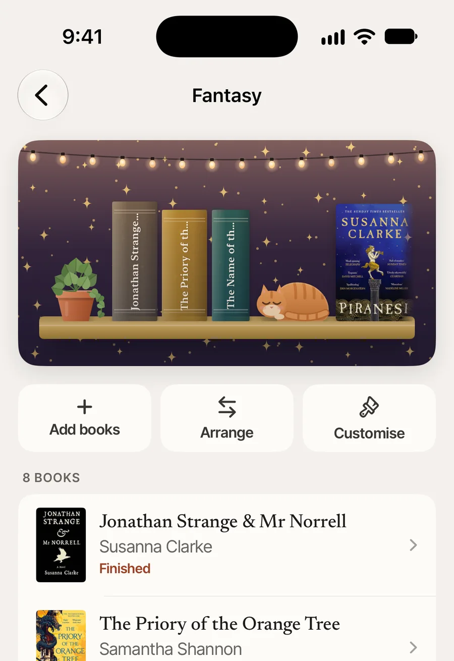A shelf called Fantasy, drawn as a shelf with fairy lights, a plant and a sleeping cat.